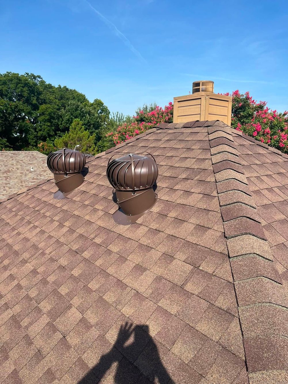 A new shingle roof and gutters on a red barn by CNB Roofing